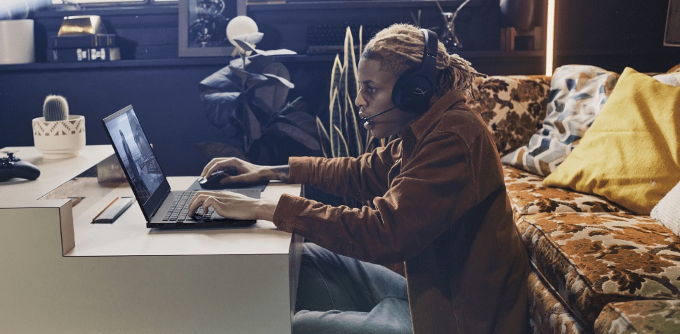 Man playing online, with headset and Omen laptop